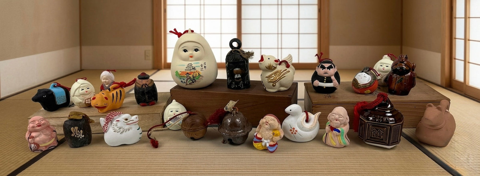 Collection of vintage Japanese folk craft figures, lucky charms, zodiac animals, and traditional ceramic ornaments displayed in a Japanese tatami room