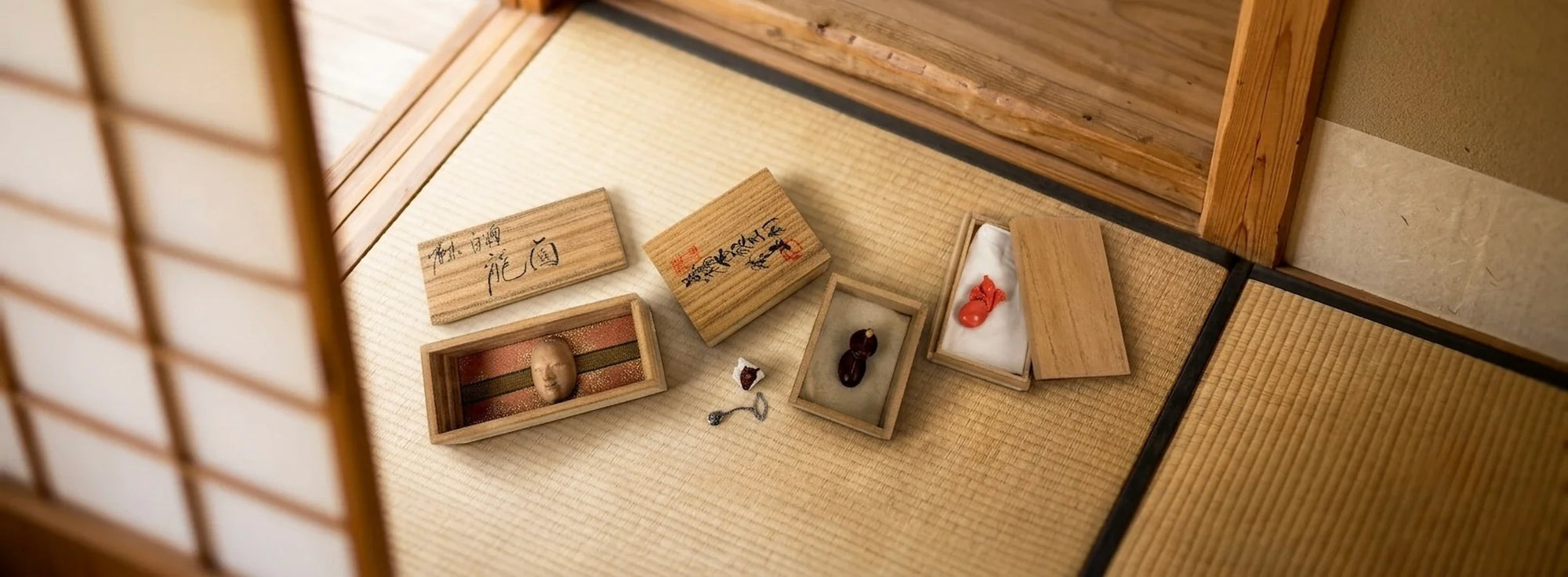 Rare Japanese antiques in presentation boxes displayed on tatami in a traditional Japanese room for dealer collaborations