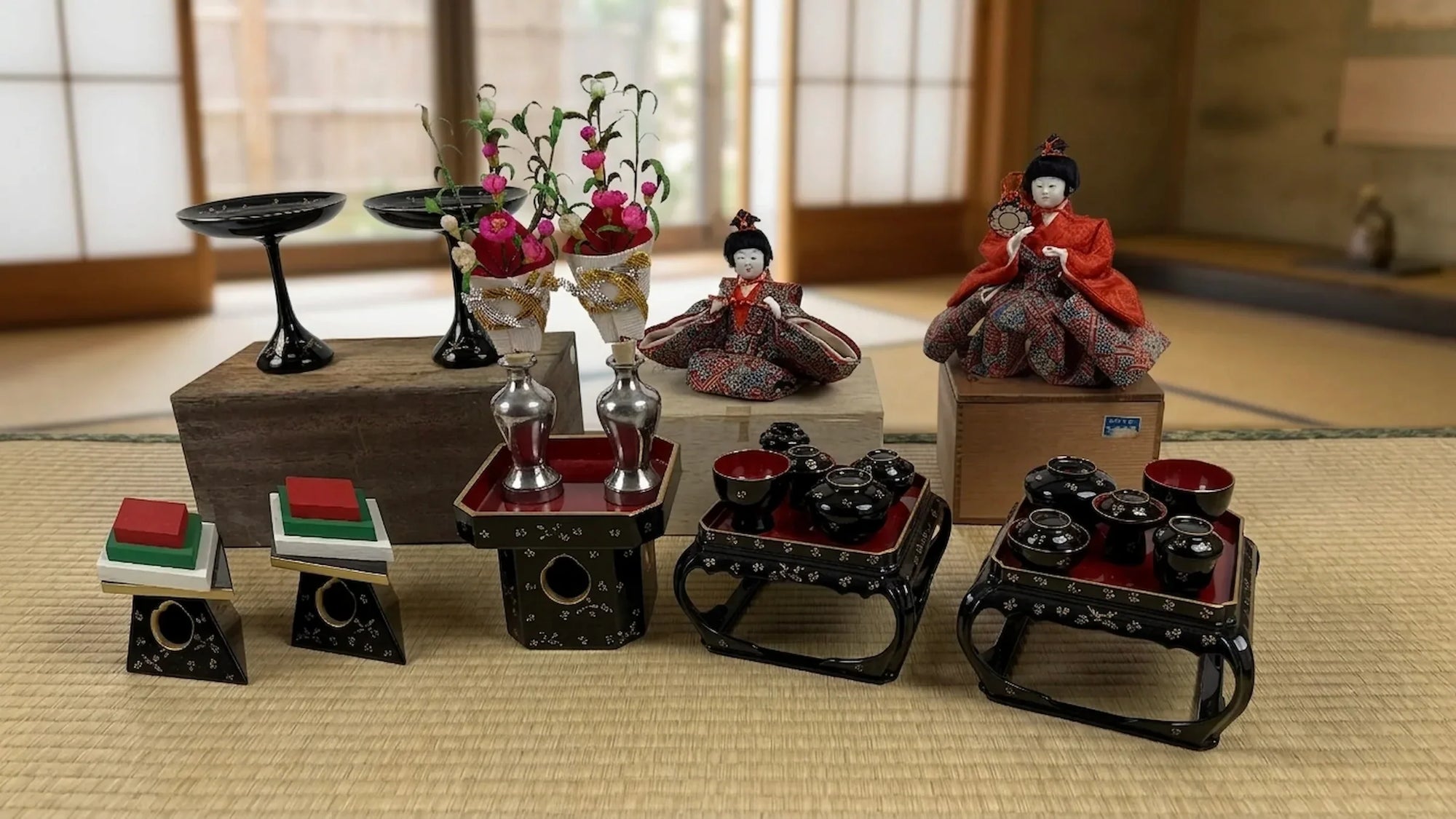 Collection of vintage Japanese hina doll furniture, lacquerware display pieces, and Hina Matsuri accessories displayed in a traditional tatami room setting