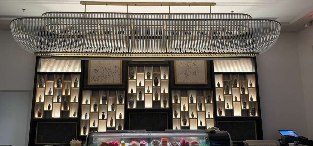 The display wall at The Ritz-Carlton, Aruba—warm light, clean lines, and a lot of history behind the glass | Chidori Vintage